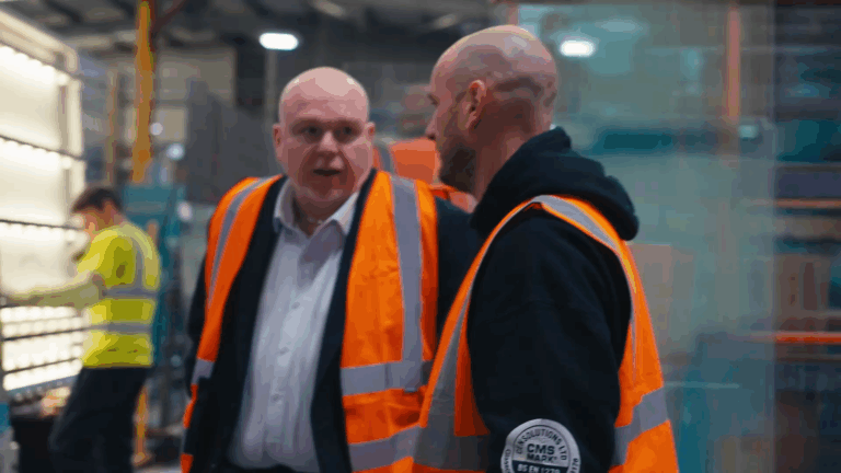men in hi-viz discussing operations