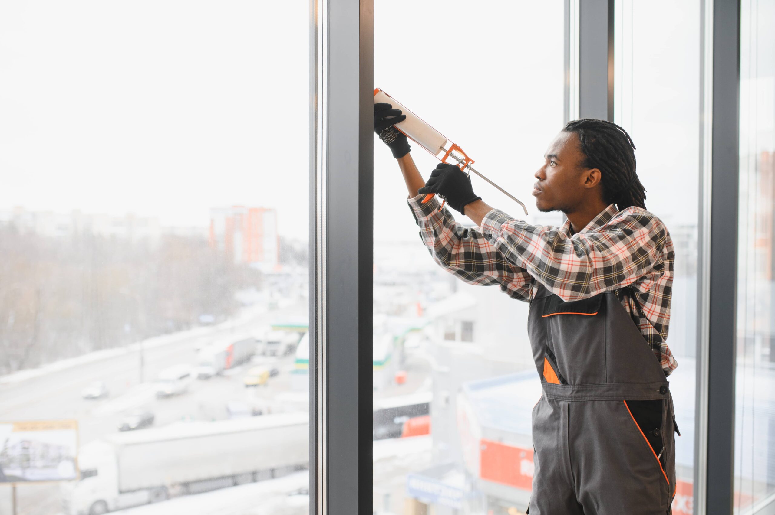 skilled worker replacing glass window
